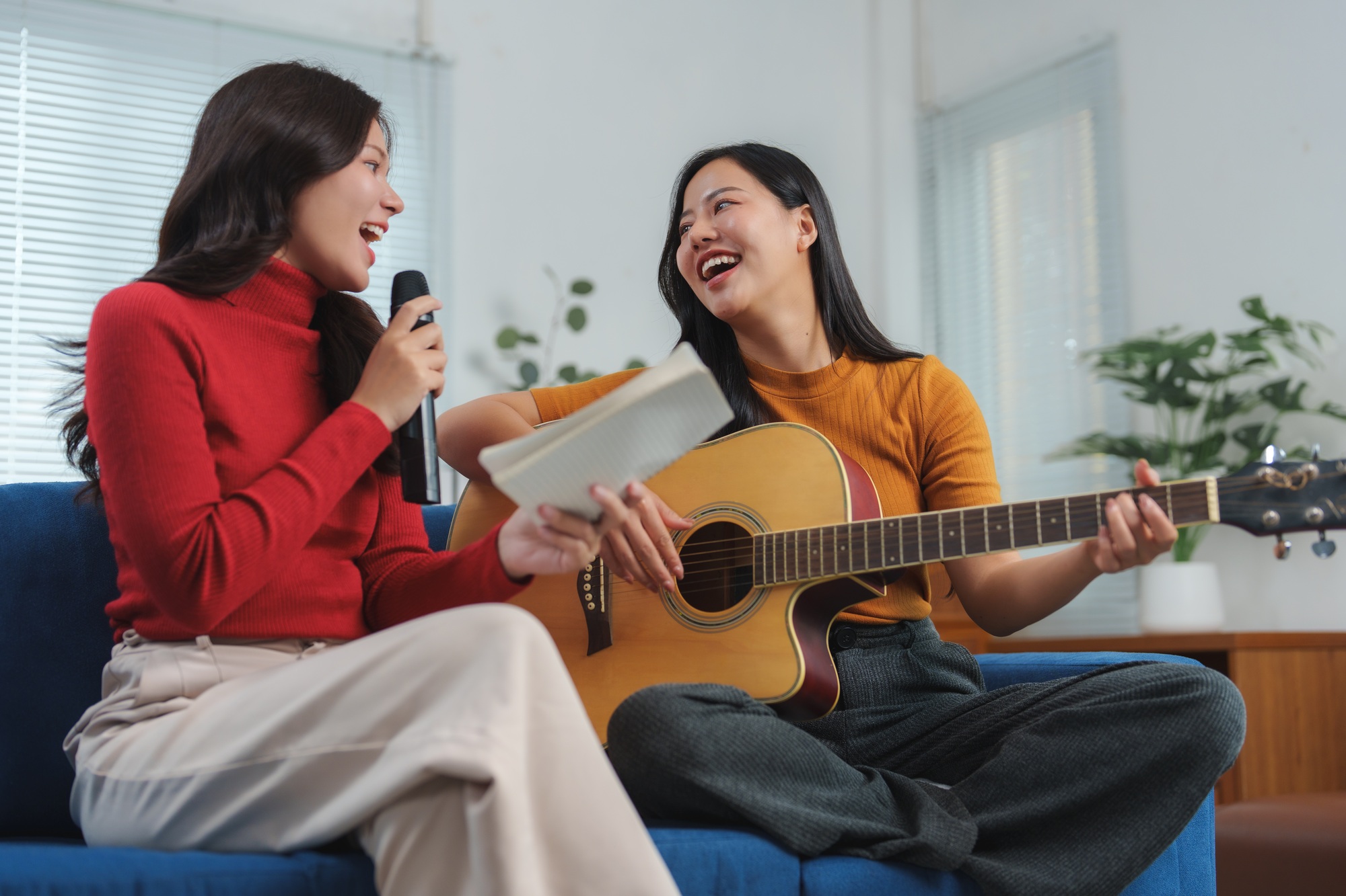 Friends enjoying music and singing together at home