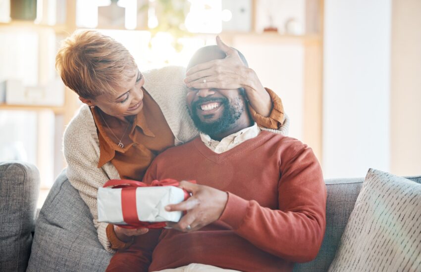 Love. black couple and surprise with present, celebrate birthday and being happy, loving and togeth