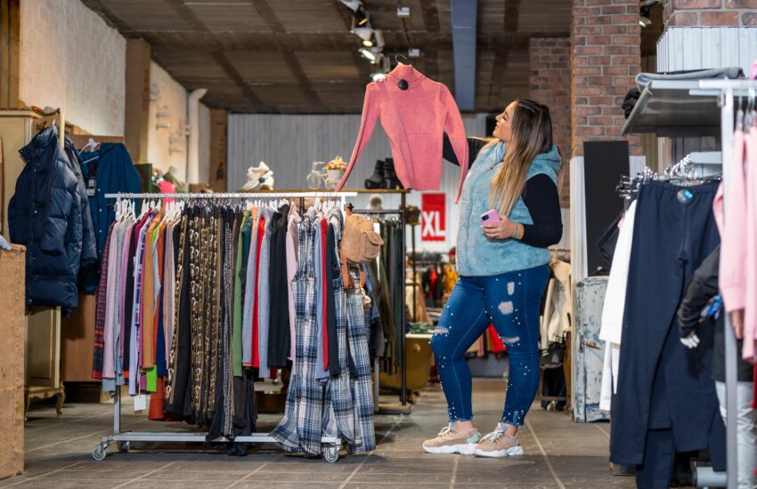 Overweight woman shops in a clothing store in the plus size section